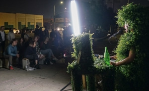 Nina on street as hedge, performing