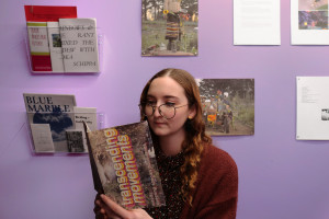 Willa reading, artworks mounted on wall