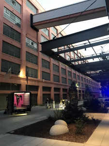 parked between buildings next to outdoor sculpted garden