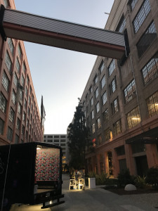 parked below connecting walkway between buildings