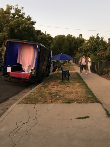 Gas parked on street, camp chairs beside