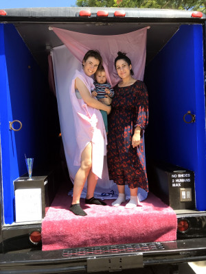 standing in back of Gas gallery, holding baby