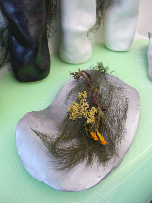 grasses, flowers, twig in shell