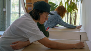 3 people writing on craft paper