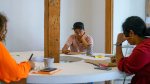 3 people writing on craft paper
