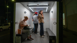 people in the back of Gas looking at artwork